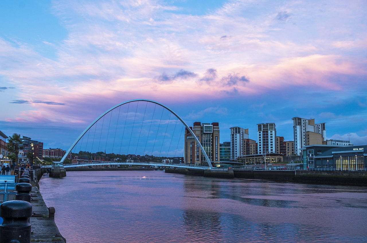 Newcastle Quayside and the Gateshead Millennium Bridge over the Tyne at dusk, home to Christmas party venues