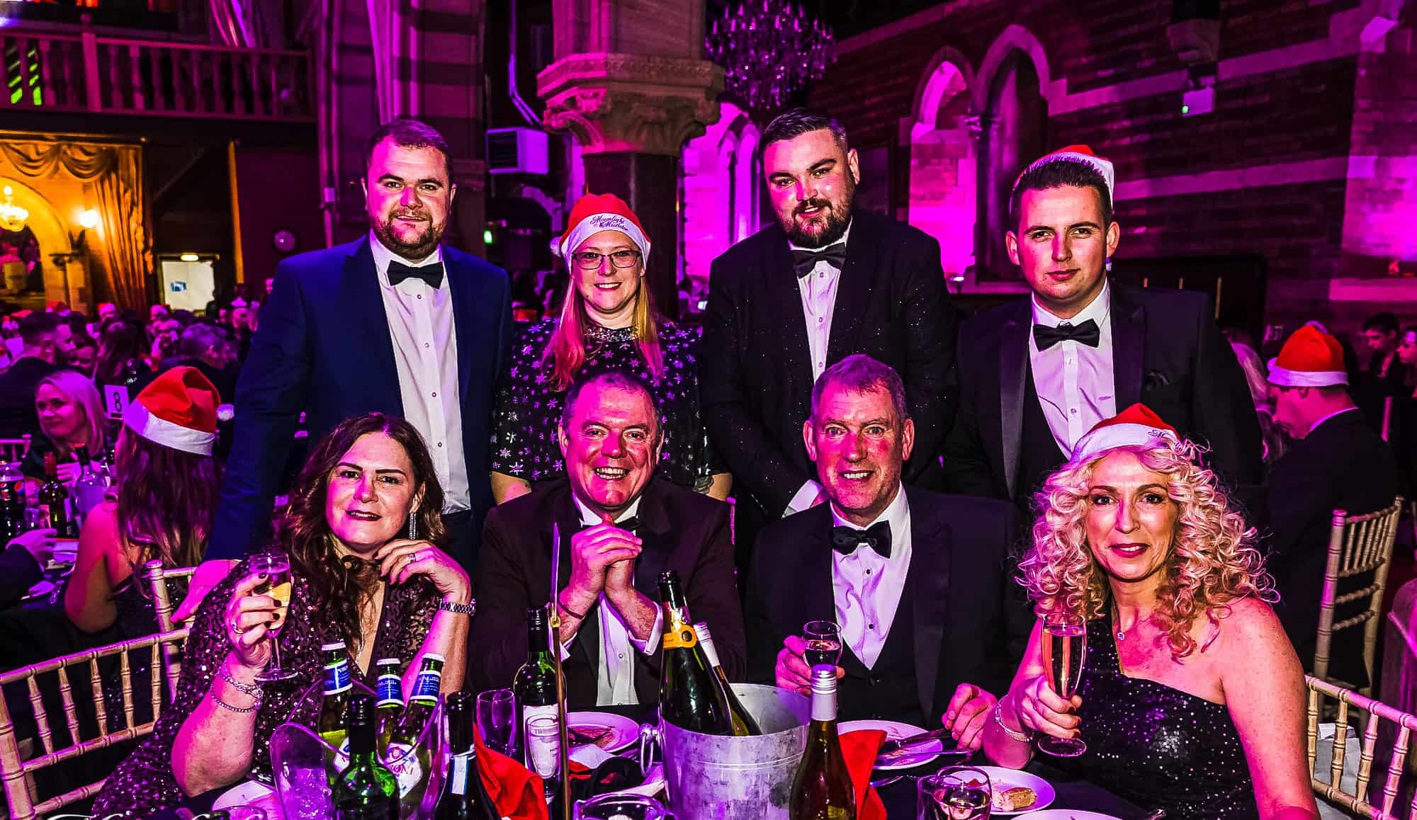 Groups of guests in black tie at a reserved dinner table during a Moonlight & Mistletoe Christmas party night at the Empire Banqueting Hall, Leicester