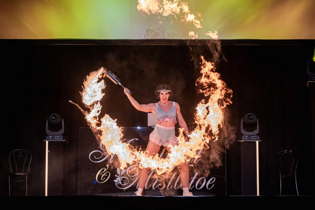 Fire performer on stage at Moonlight & Mistletoe Winter Carnival Christmas party night at the ICC Birmingham