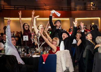 Work colleagues celebrating at a Christmas party night in Birmingham at the ICC